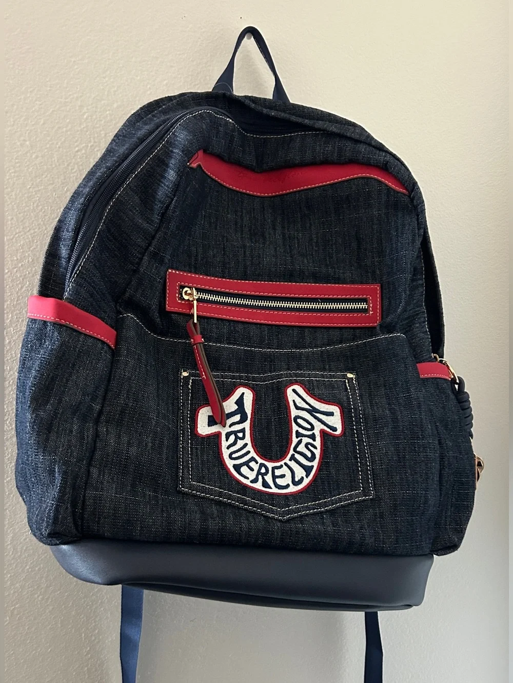 True Religion Dark Denim Backpack with Red Accents